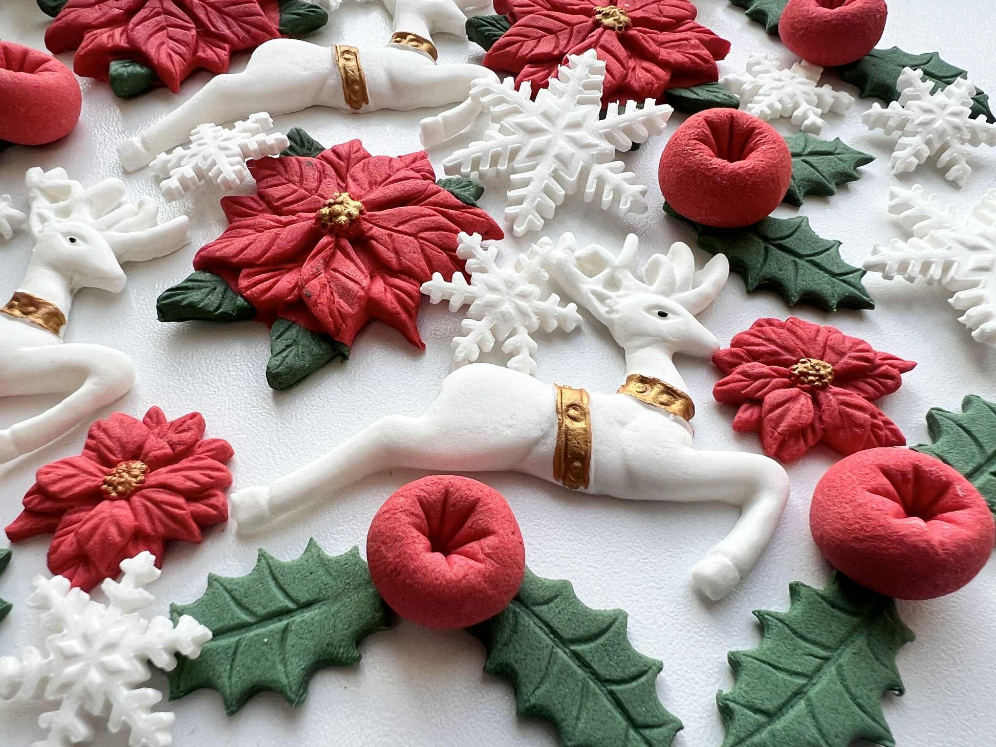 Edible fondant reindeer with snowflakes and holly leaves