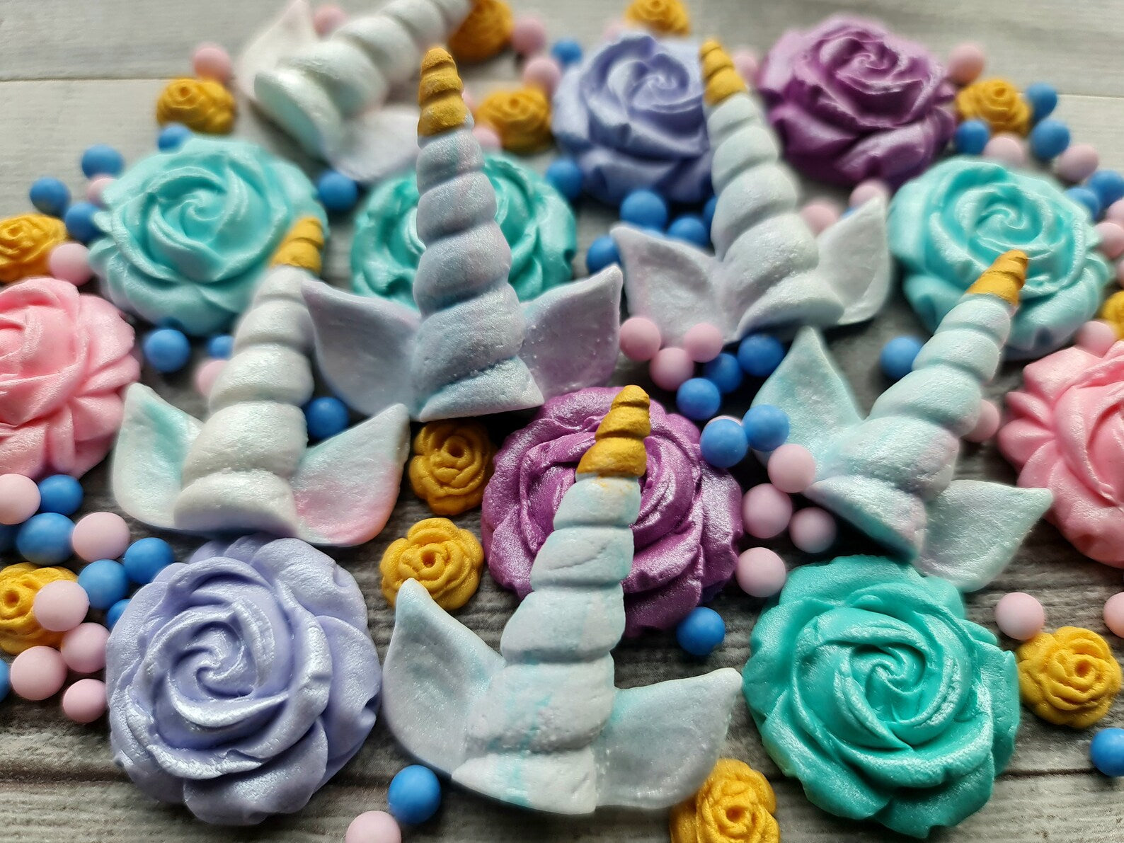 Unicorn cake decoration set with pastel flowers and sugar pearls