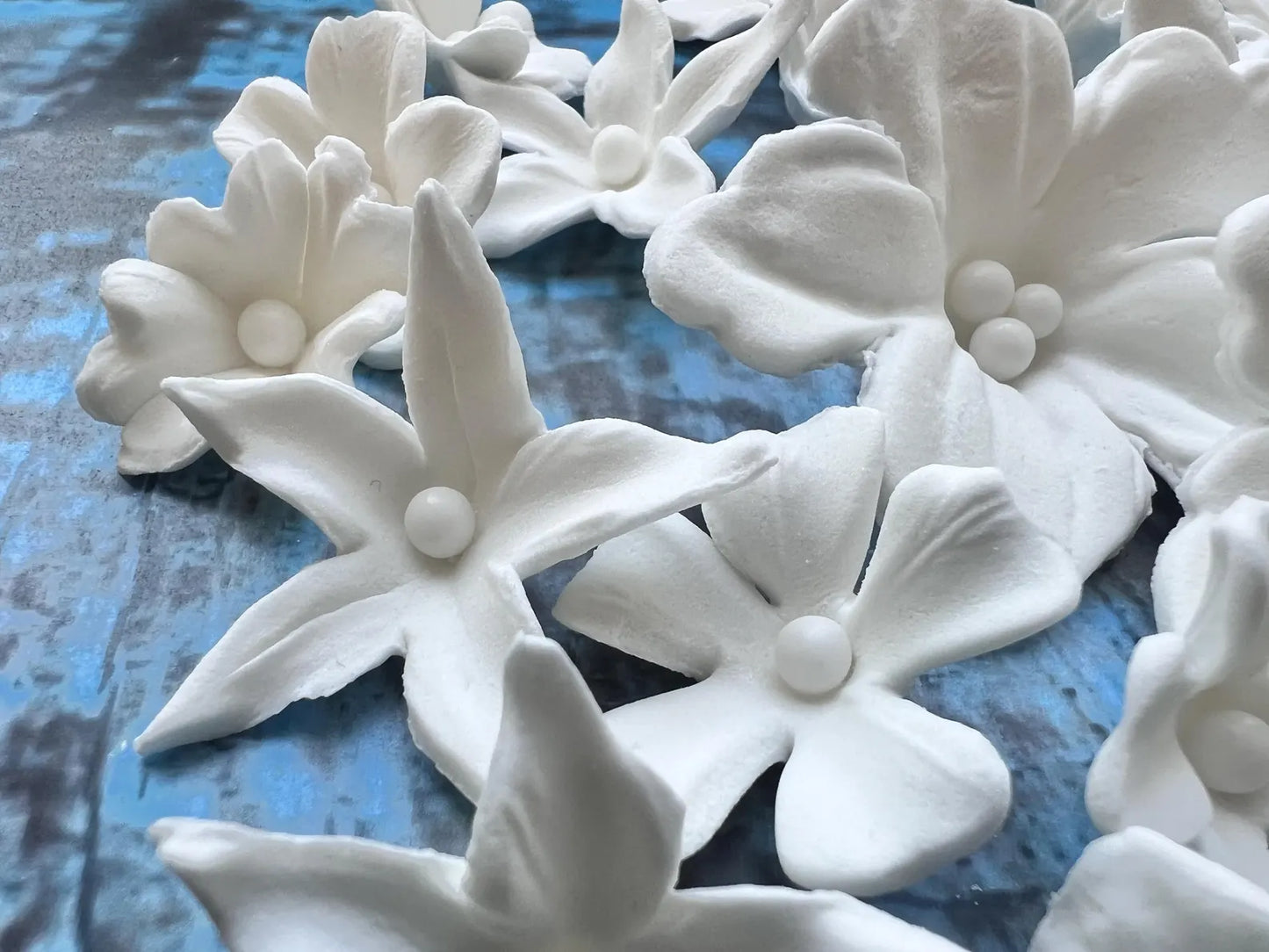 White fondant flowers showing texture and pearl centers