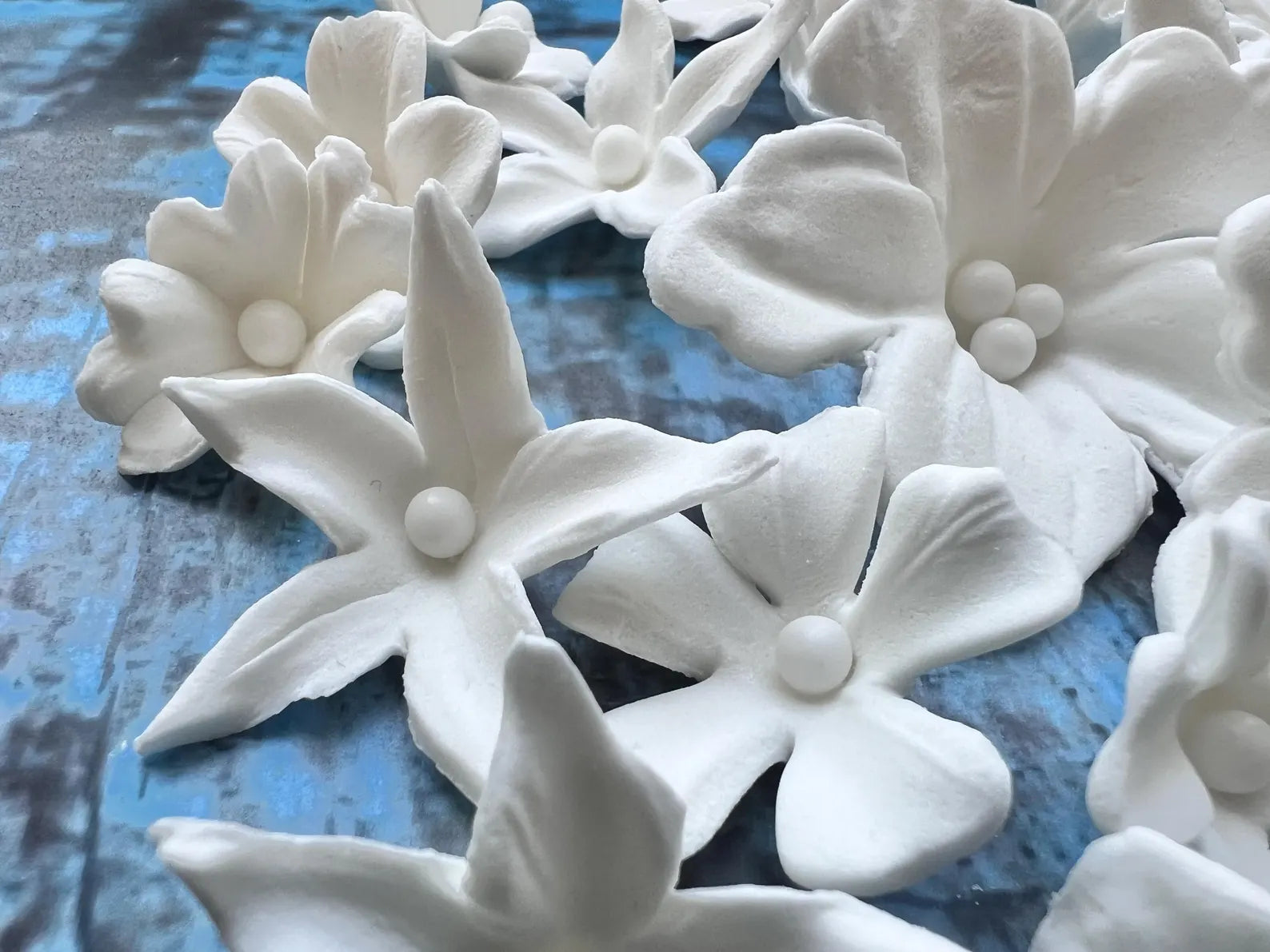 White fondant flowers showing texture and pearl centers