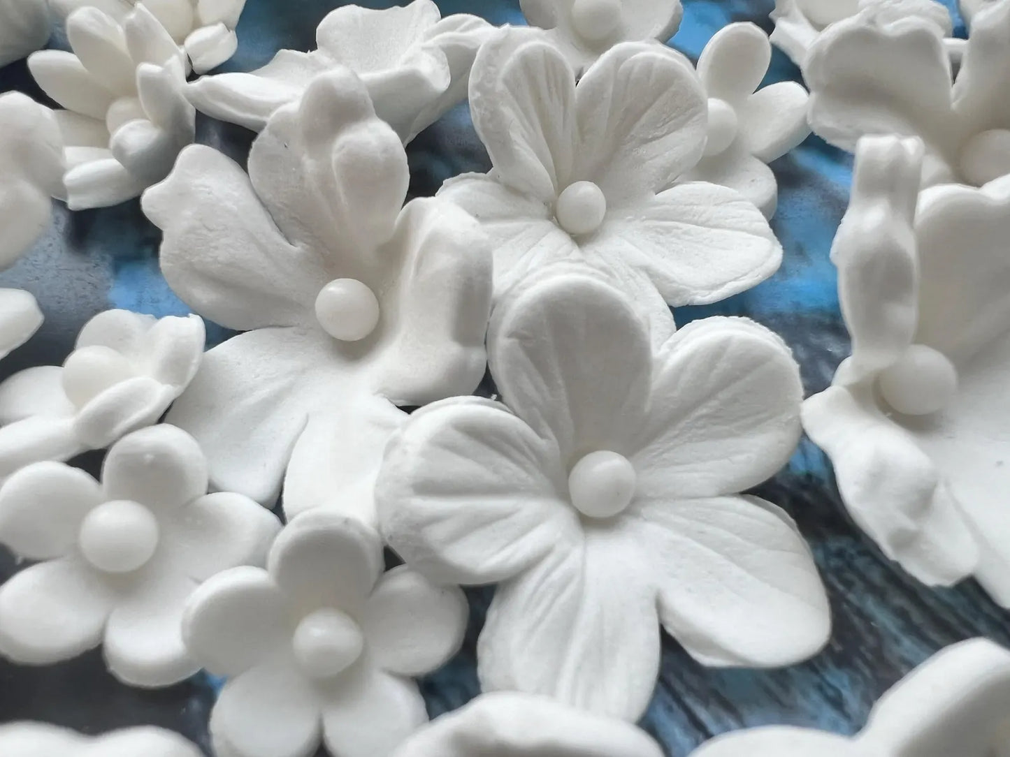 Edible white sugar flower decorations with detailed petal texture
