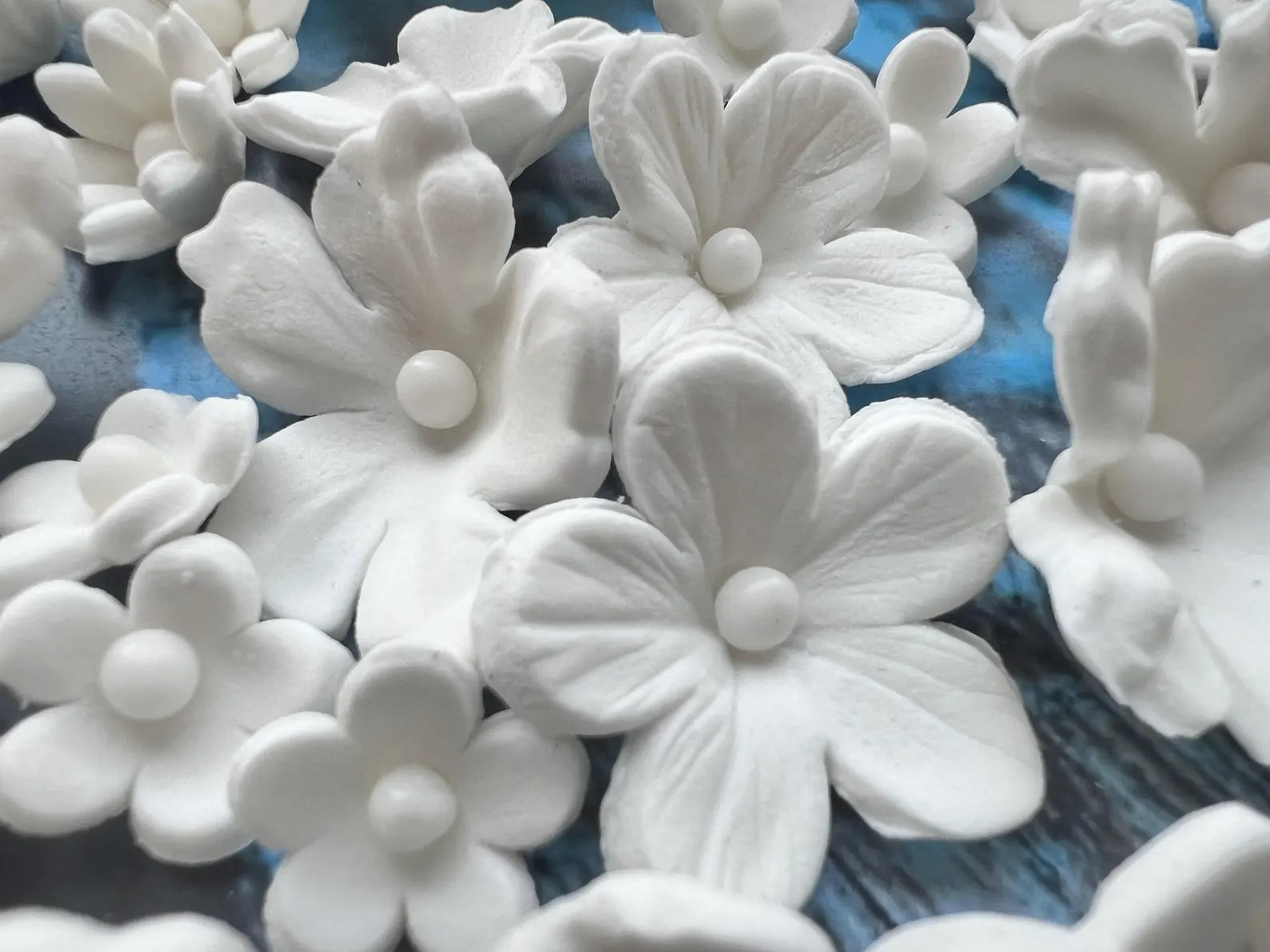 Edible white sugar flower decorations with detailed petal texture