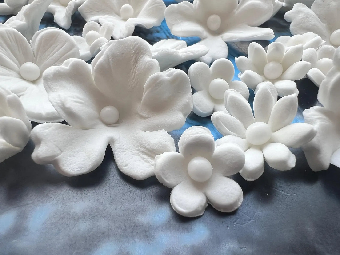 Handmade white fondant flowers showing fine floral details