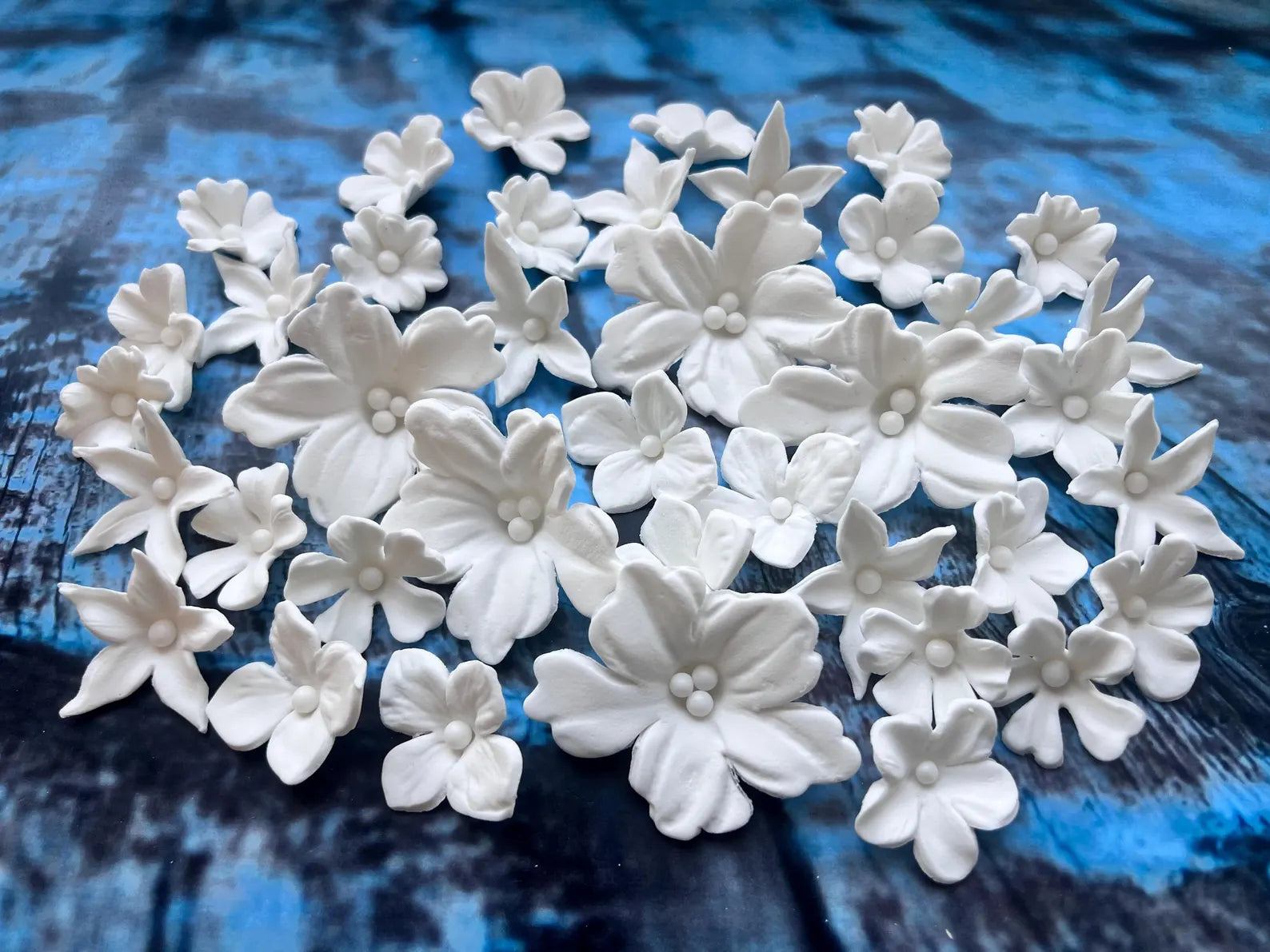 Handmade white edible fondant flowers in assorted sizes for cake decorating