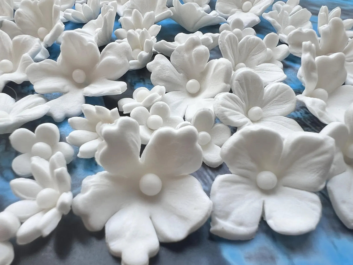 Assorted white fondant flower cake toppers close-up view