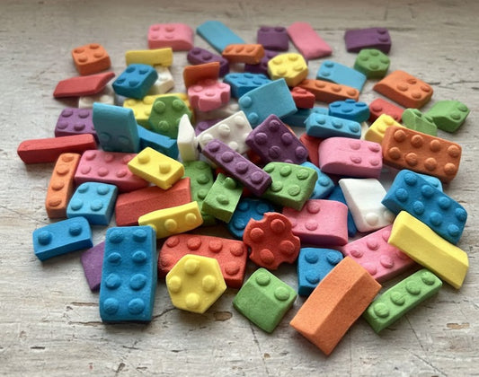Colorful fondant building blocks on a wooden surface